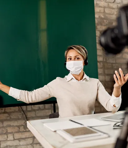 Teacher delivering a lesson to camera
