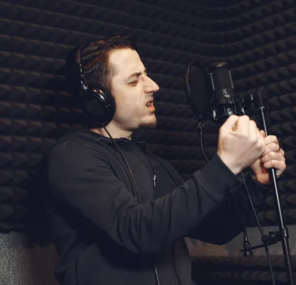 Independent broadcaster speaking into a studio microphone