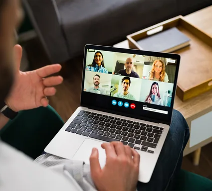 Group coaching session displayed on a laptop