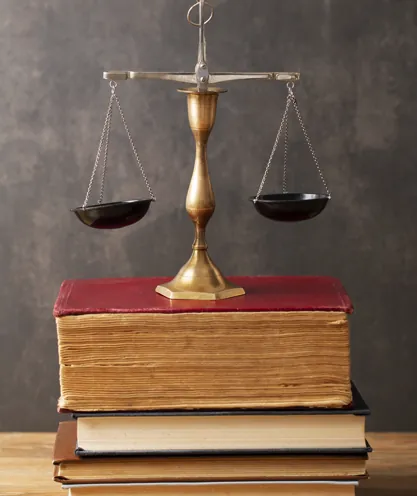 Balance scale resting on a law book