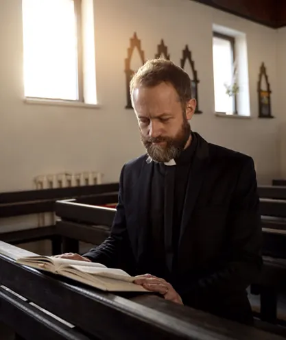 Minister reading a Bible in a church