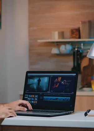 Creator reviewing recorded video on a laptop