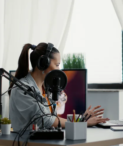 Creator recording a live broadcast with a camera and microphone