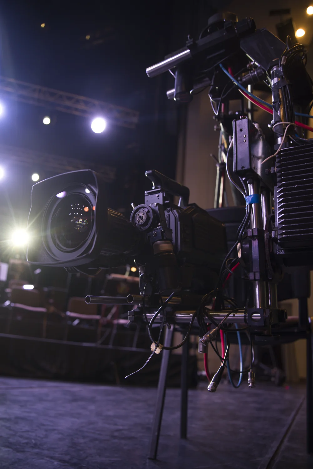 Professional broadcast cameras at a live event.