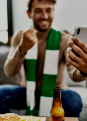 Supporter checking a match on a phone