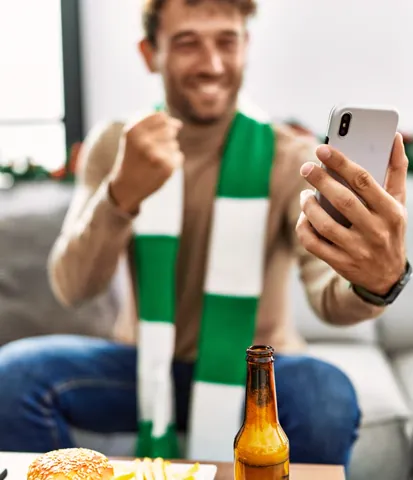Sports supporter watching on a phone