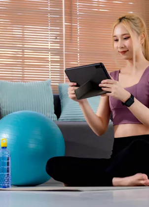 Member watching a fitness lesson on a tablet