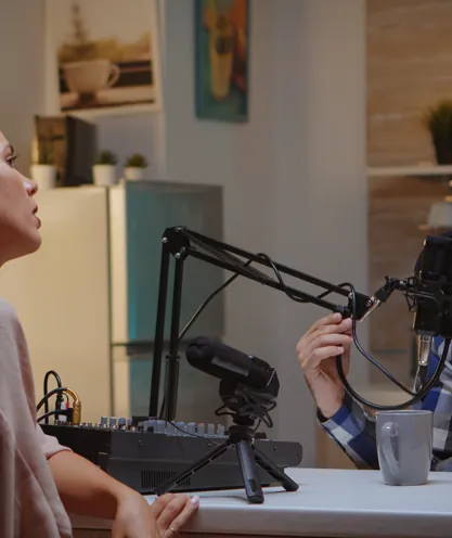 Podcast hosts talking across microphones