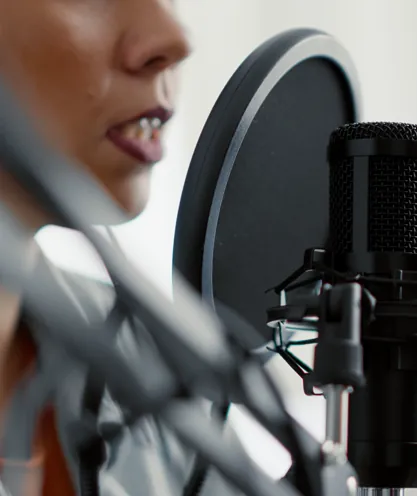 Host recording a podcast with a studio microphone