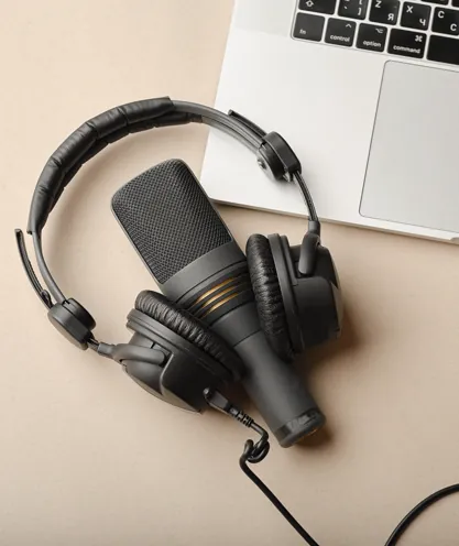 Microphone and headphones on a studio desk