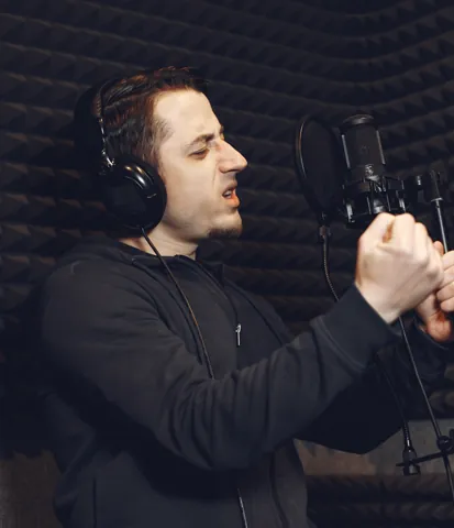 Radio host speaking into a studio microphone