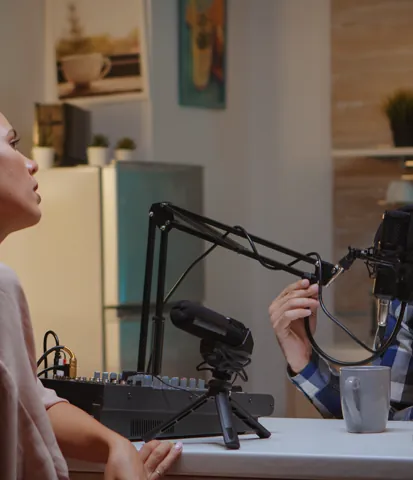 Two hosts recording a podcast together