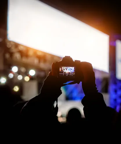 Attendee recording a concert stage