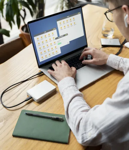 Operator checking a laptop at a production desk