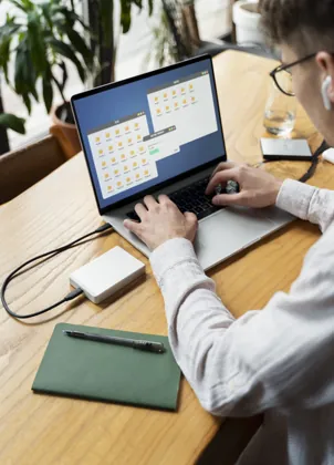 Operator checking a laptop and external drive
