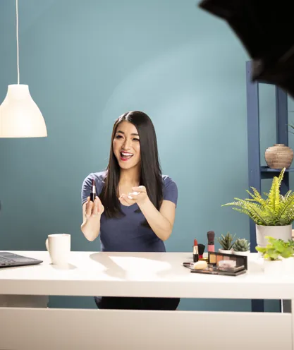 Beauty presenter answering questions while filming a product review