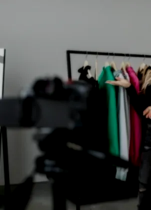 Fashion host presenting clothes to a video camera