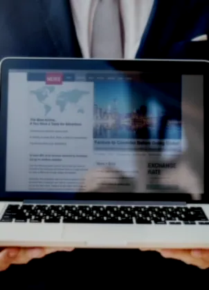 Editor preparing a news page on a laptop