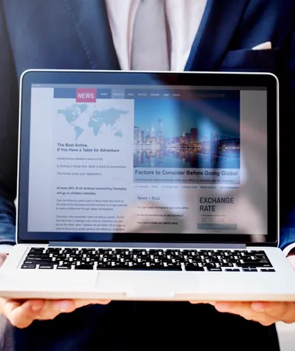 Presenter using a laptop for a news broadcast