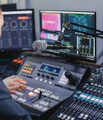 Studio engineer working with broadcast controls
