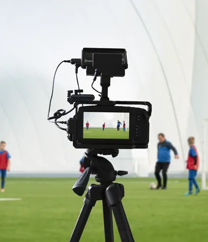 Camera filming a football game
