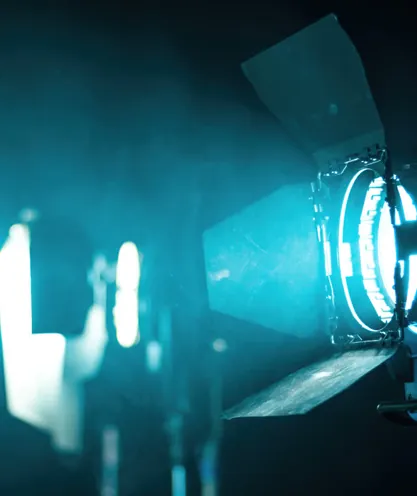 Camera pointed toward a lit stage