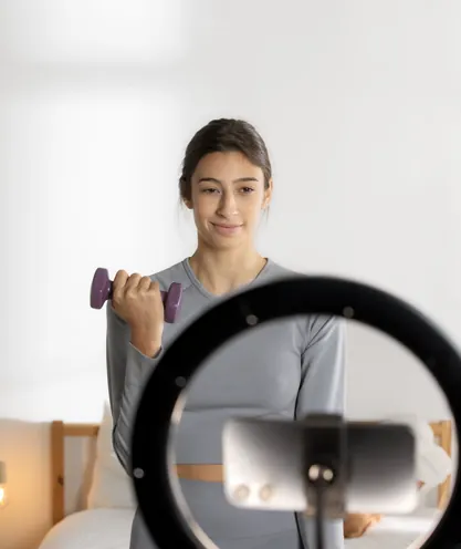 Fitness instructor filming a workout