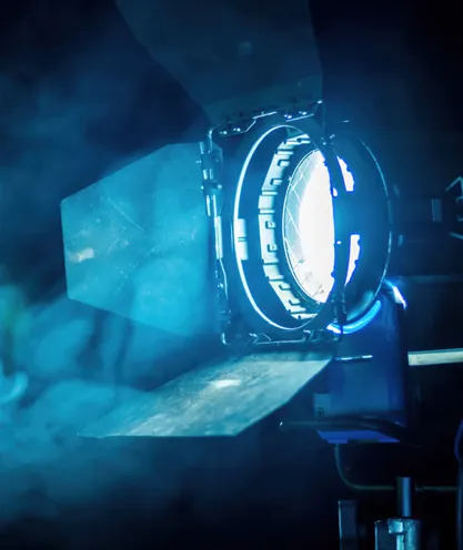 Camera facing a lit performance stage