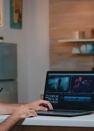 Editor preparing recorded video on a laptop