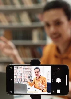 Instructor checking a lesson on a phone camera