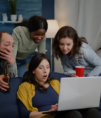 Friends watching video together on a laptop