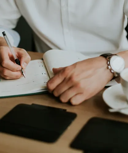 Participant recording goals and notes in a notebook