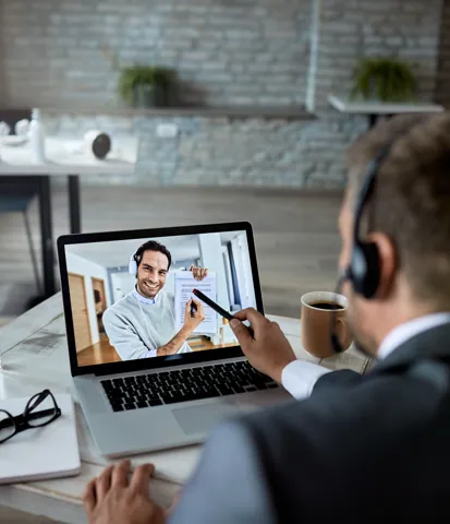 One-to-one coaching conversation on a laptop
