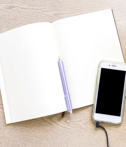 Open planner and phone ready for scheduling