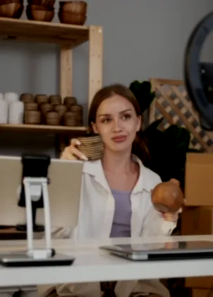 Merchant presenting handmade products to a phone camera