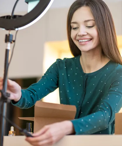 Product presenter preparing a phone camera and ring light