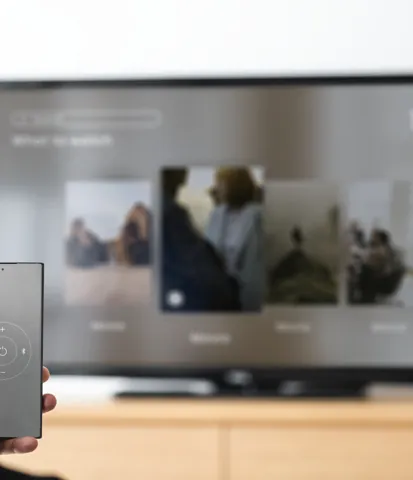 Viewer choosing a video on a television with a phone