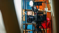 a video camera on a tripod ready to record an event