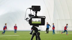 a camera on a tripod streaming a youth soccer game